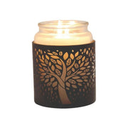 Jar candle placed inside tree of life wax burner, glowing softly

