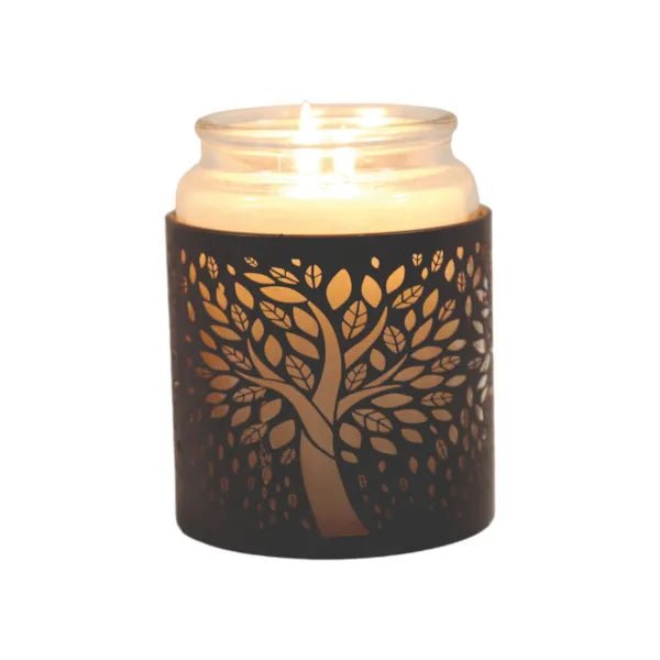 Jar candle placed inside tree of life wax burner, glowing softly

