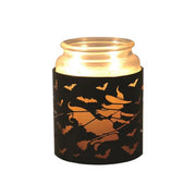 Jar candle placed in witch-on-broomstick Halloween wax melt burner

