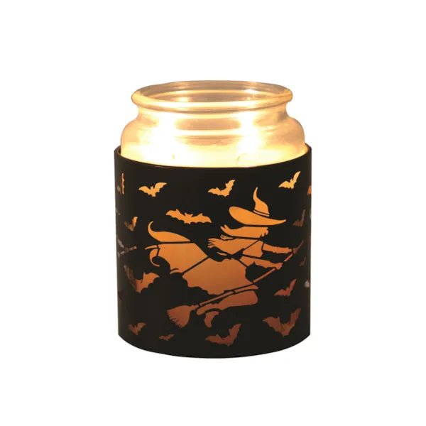 Jar candle placed in witch-on-broomstick Halloween wax melt burner

