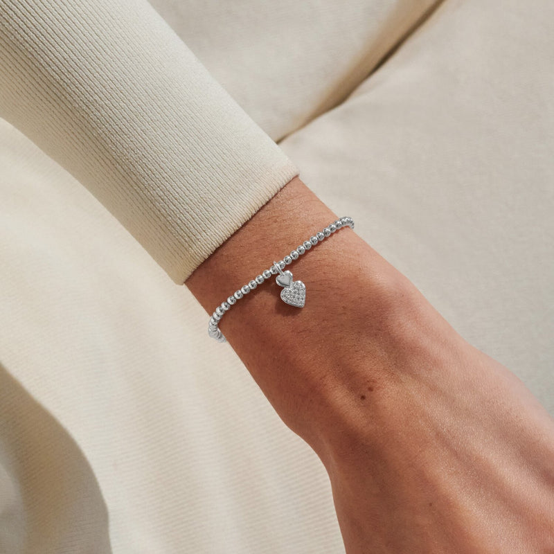 Joma Jewellery double-heart bracelet worn on wrist