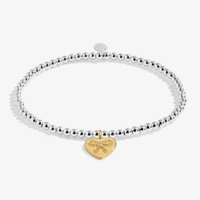 Joma A Little To My Bestie On Your Birthday Bracelet laid flat, silver-plated beaded stretch Bracelet with gold charm.