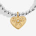 Close-up of Joma A Little Bestie Birthday Bracelet charm, gold heart with bow and crystal detail.
