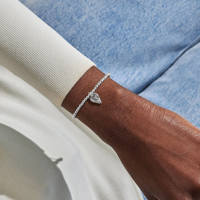 Silver-plated beaded Bracelet worn on wrist with hammered heart charm and tiny crystal star detail
