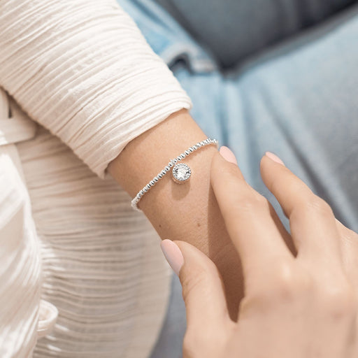 Joma A Little Happy 60th Birthday Bracelet worn on wrist, silver-plated beaded stretch Bracelet with a crystal round charm.