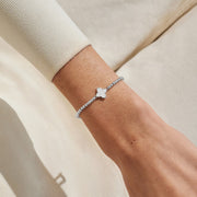 Silver-plated beaded Bracelet worn on wrist with mother of pearl clover charm in a silver setting