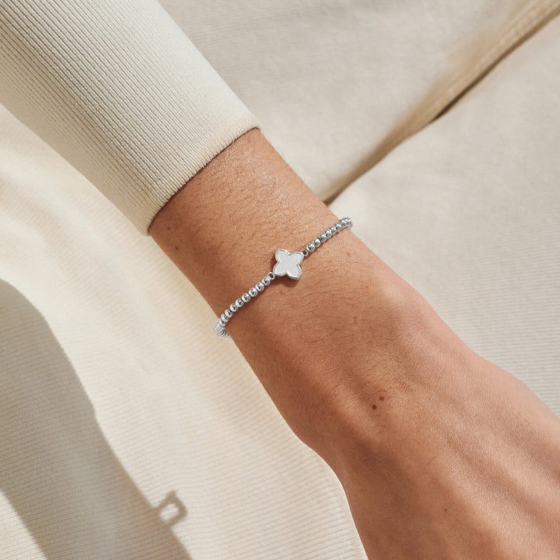 Silver-plated beaded Bracelet worn on wrist with mother of pearl clover charm in a silver setting