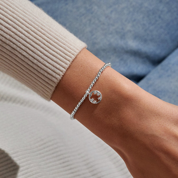 Silver-plated beaded Bracelet worn on wrist with circular star charm and crystal star details