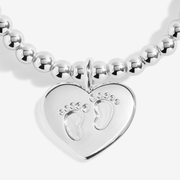 Close-up of the silver-plated heart charm with tiny baby footprints