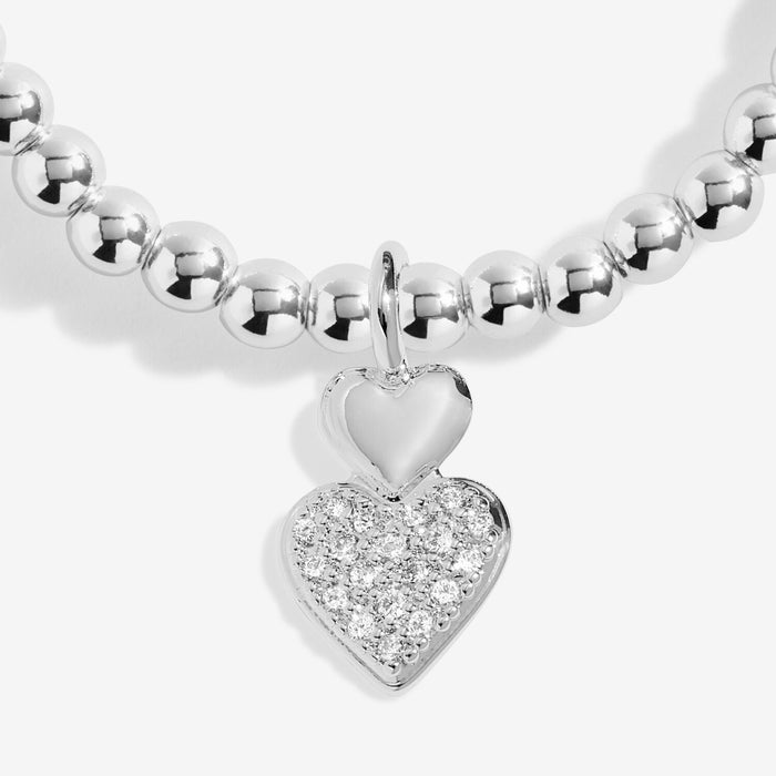 Close-up of double heart charm with pavé crystal heart on silver-plated beaded Bracelet