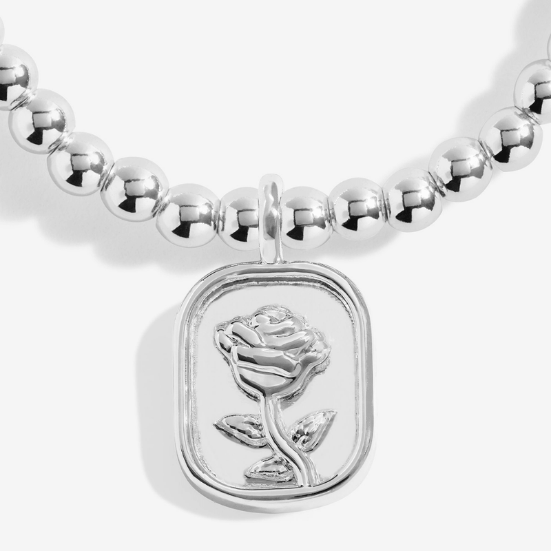Close-up of silver rose medallion charm on Joma Jewellery bracelet