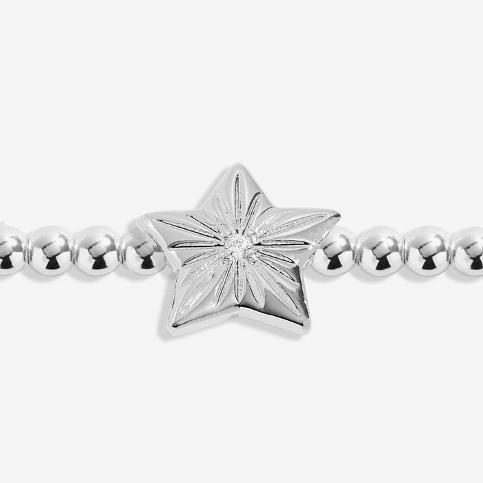 Close-up of star charm with engraved rays and crystal centre on silver-plated beaded Bracelet