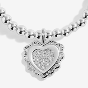 Close-up of the sparkling heart charm on the Joma family Christmas bracelet