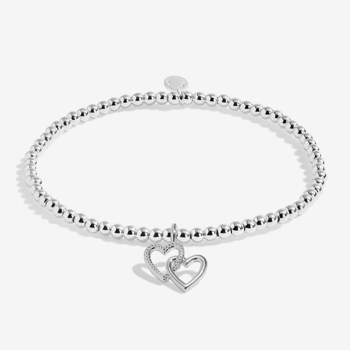 Joma silver-plated stretch Bracelet with double open heart charm displayed on a white background