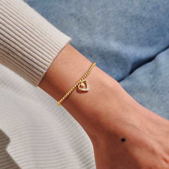 Gold-plated Joma Jewellery beaded Bracelet worn on wrist with open heart charm and sparkling crystal detail, Happy Mother’s Day Bracelet.