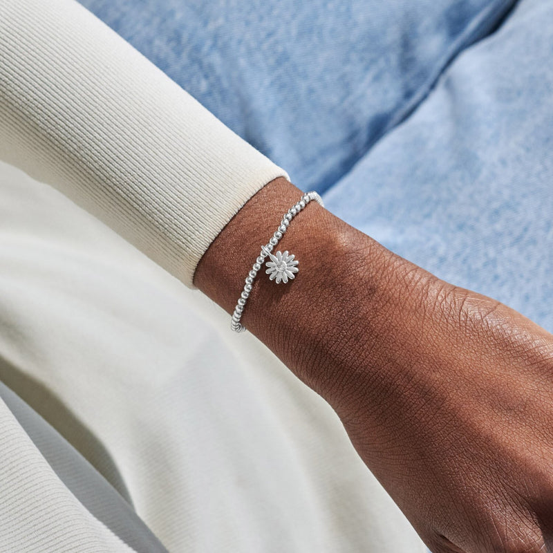 Silver-plated Joma Jewellery beaded Bracelet worn on wrist with daisy charm and heart crystal centre, Mother’s Day gift for Mum.