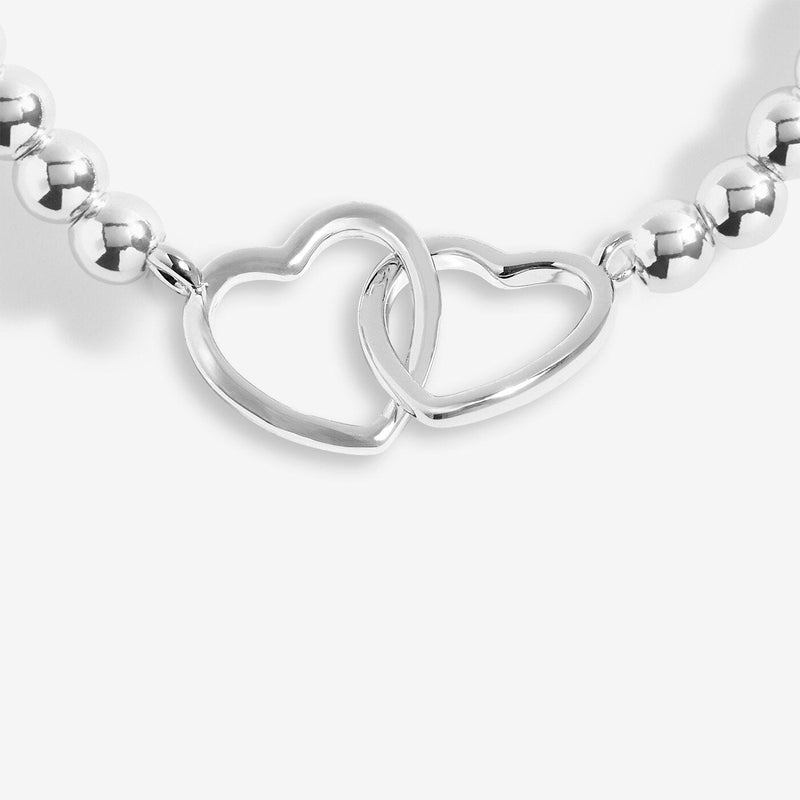 Close-up of Joma Friendship bracelet double-heart charm
