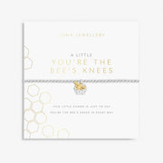 Joma Jewellery Bee’s Knees bracelet displayed on white honeycomb gift card, playful present for her.


