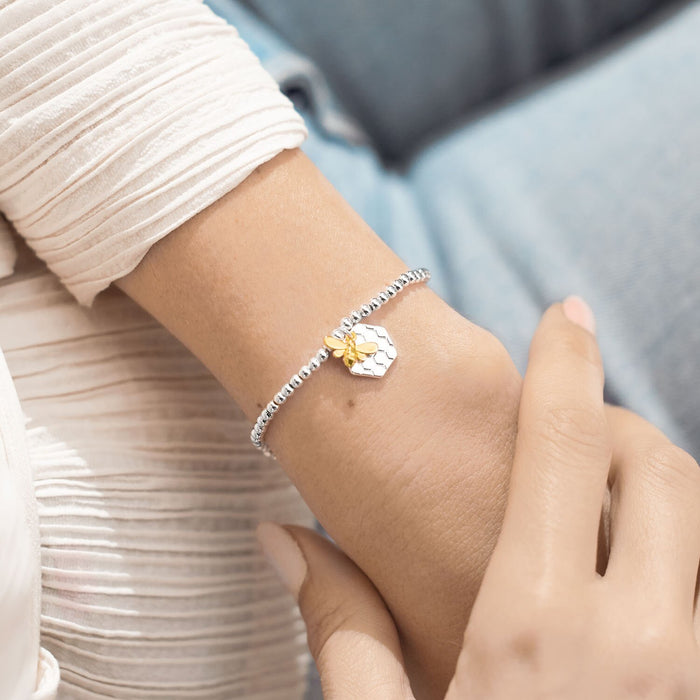 Joma Jewellery ‘Bee’s Knees’ silver beaded bracelet with gold bee charm on wearer’s wrist – sweet gift for her.
