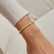 Gold crystal slider bracelet styled on wrist, displaying brilliant stones and smooth slider for a personalised fit.