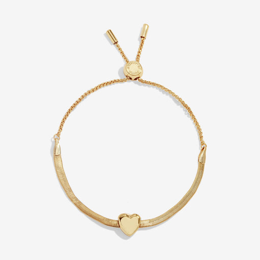 Joma Jewellery gold‑plated herringbone slider bracelet with polished heart slider charm, product shot on white background.
