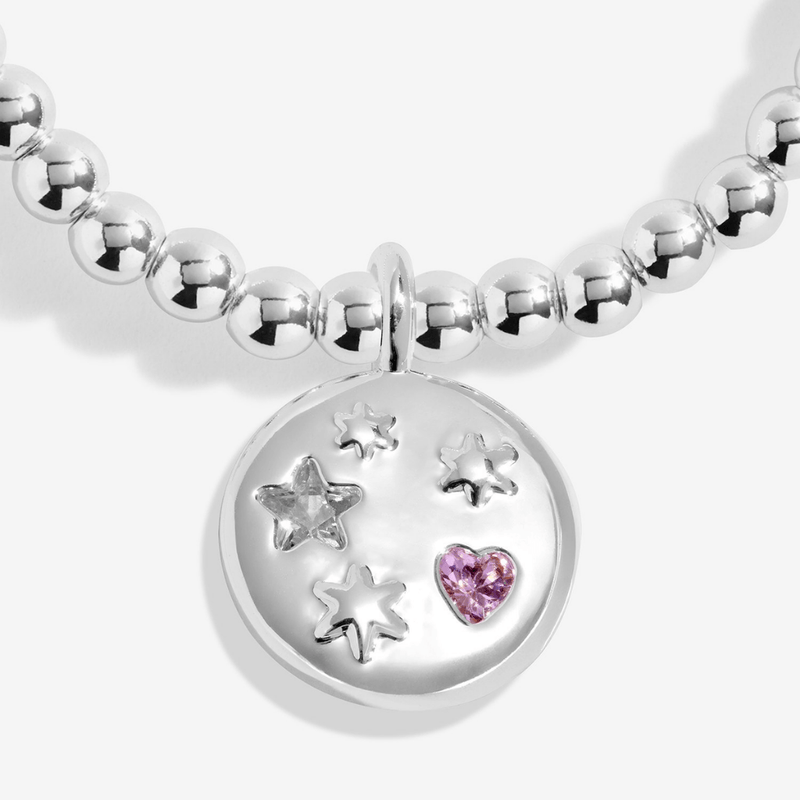 Starry silver disc charm with sparkling pink heart detail