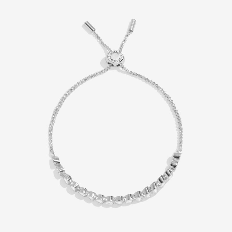 Joma Jewellery silver‑tone slider bracelet with bezel‑set clear crystals, product shot on white background.
