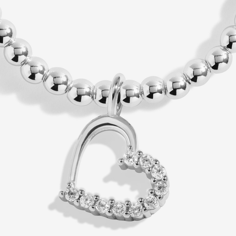 Close-up of the sparkling open-heart charm on the Joma With Love Bracelet