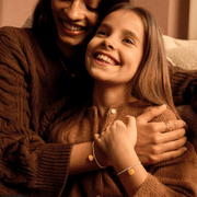 Child wearing Joma Jomees pumpkin bracelet with matching adult bracelet