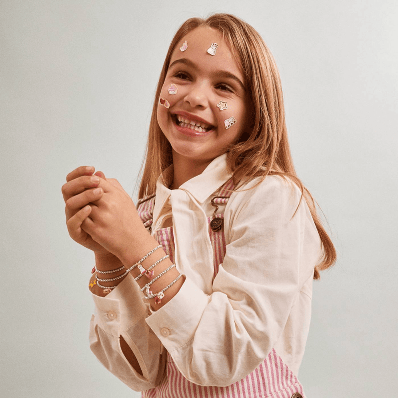 Child wearing Joma Jomees unicorn bracelet with colourful kids bracelets