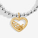 Close-up of gold heart charm with honeycomb and bee detail on beaded Bracelet