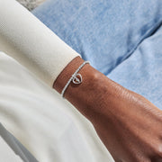 Silver-plated Joma Jewellery beaded Bracelet worn on wrist with open heart charm and angel feather detail, Mums Are Angels In Disguise.