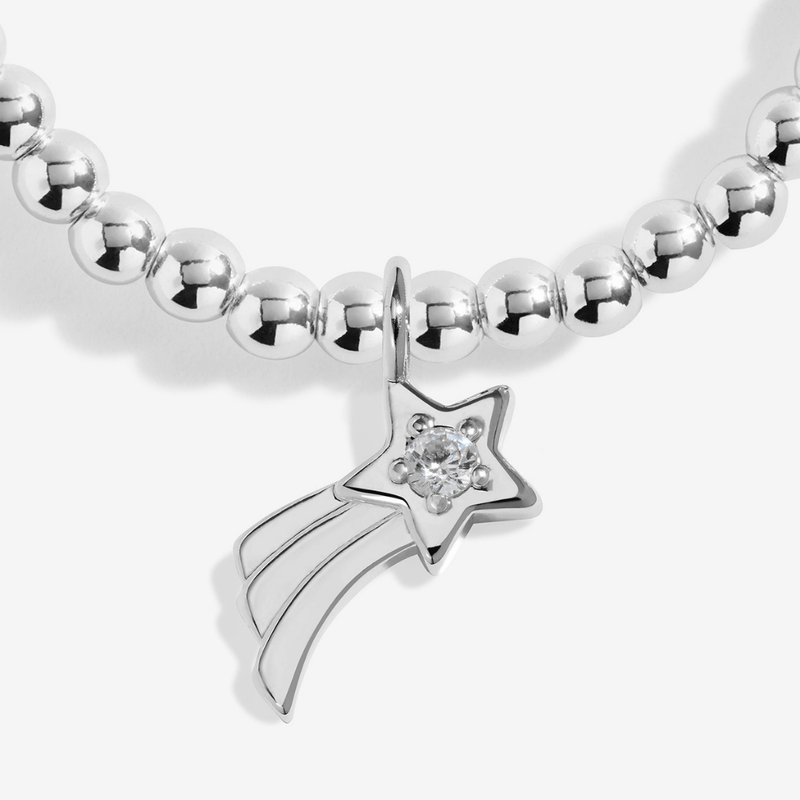 Close-up of the sparkling shooting-star charm on the Joma Secret Santa Bracelet