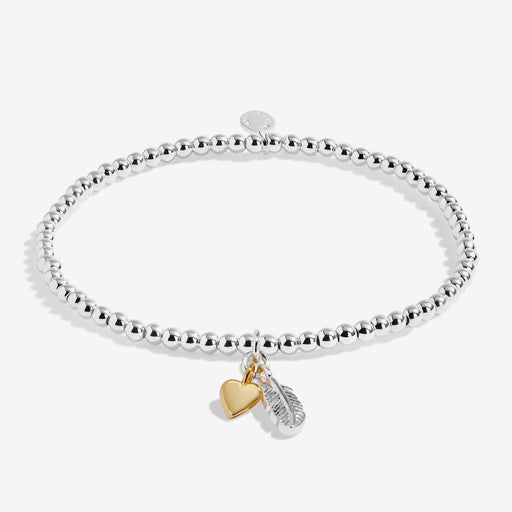 Joma stretch Bracelet with silver beads, feather charm and gold heart charm displayed on white background