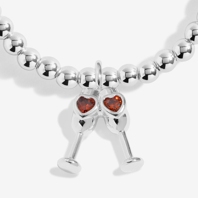 Close-up of Joma Sip Sip Hooray bracelet champagne charm
