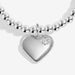 Close-up of silver heart charm with star-set crystal detail on silver beaded stretch Bracelet