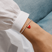 Joma Jewellery strawberry charm bracelet worn on the wrist