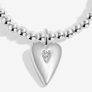 Close-up of silver heart charm with sparkling details on Joma Mum bracelet