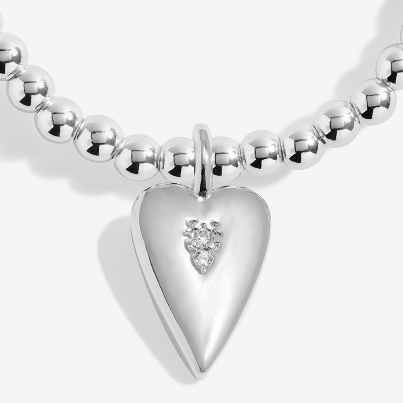 Close-up of silver heart charm with sparkling details on Joma Mum bracelet