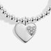 Close-up of Joma Jewellery silver heart charm with glitter heart detail on a silver-plated beaded Bracelet.