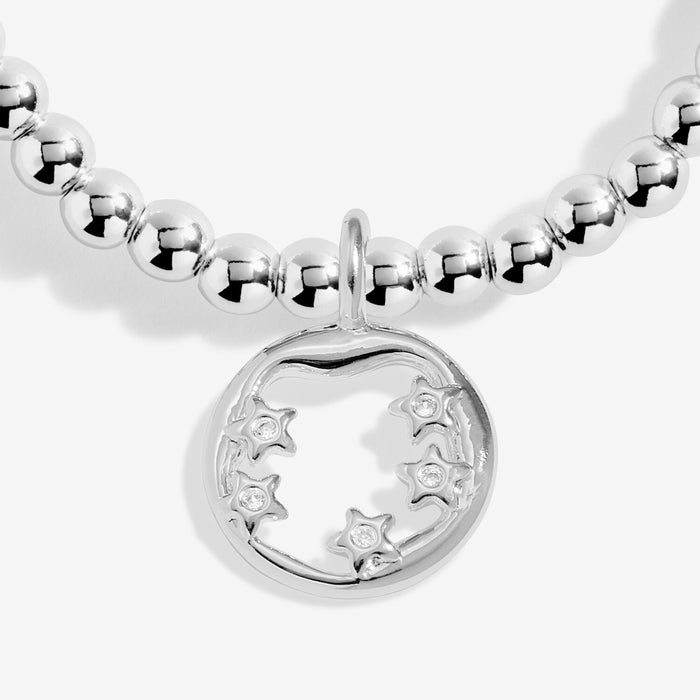 Close-up of circular star charm with crystal star accents on silver-plated beaded Bracelet