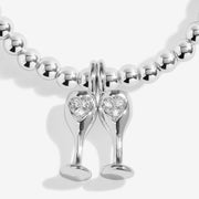 Close‑up of pavé‑heart champagne‑flute charm on Joma Jewellery Christmas Cheers bracelet, set on sterling‑silver beads.

