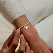 Joma Jewellery Christmas beaded bracelet styled on wrist; cute robin charm – thoughtful festive gift for her.
