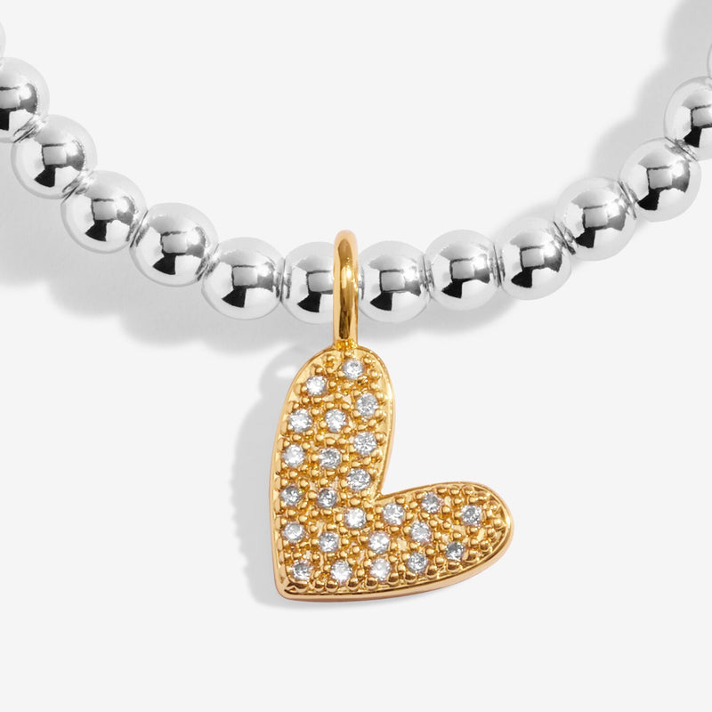 Close-up of Joma Love You To Bits bracelet gold heart charm