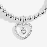 Close‑up pavé heart outline and hanging mini heart on Joma Jewellery bead bracelet – chic Joma bracelets, perfect gifts for women.
