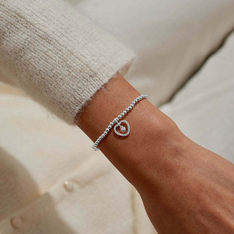 Pavé heart charm bracelet by Joma Jewellery styled on wrist – elegant silver bracelets, ideal gifts for women.
