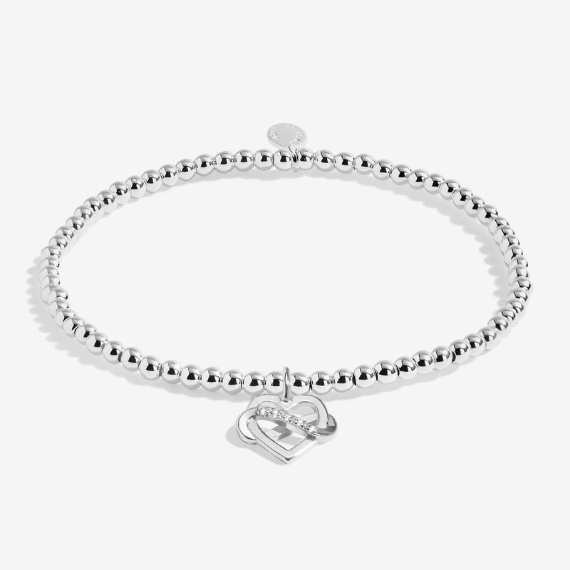 Joma Jewellery silver beaded bracelet with infinity‑wrapped heart charm – elegant bracelets, gifts for her and women.
