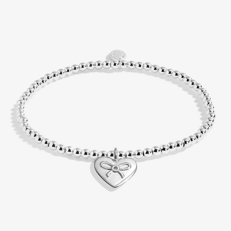 Joma Jewellery A Little “Merry Christmas Amazing Auntie” bracelet – silver beads with engraved bow‑heart charm.
