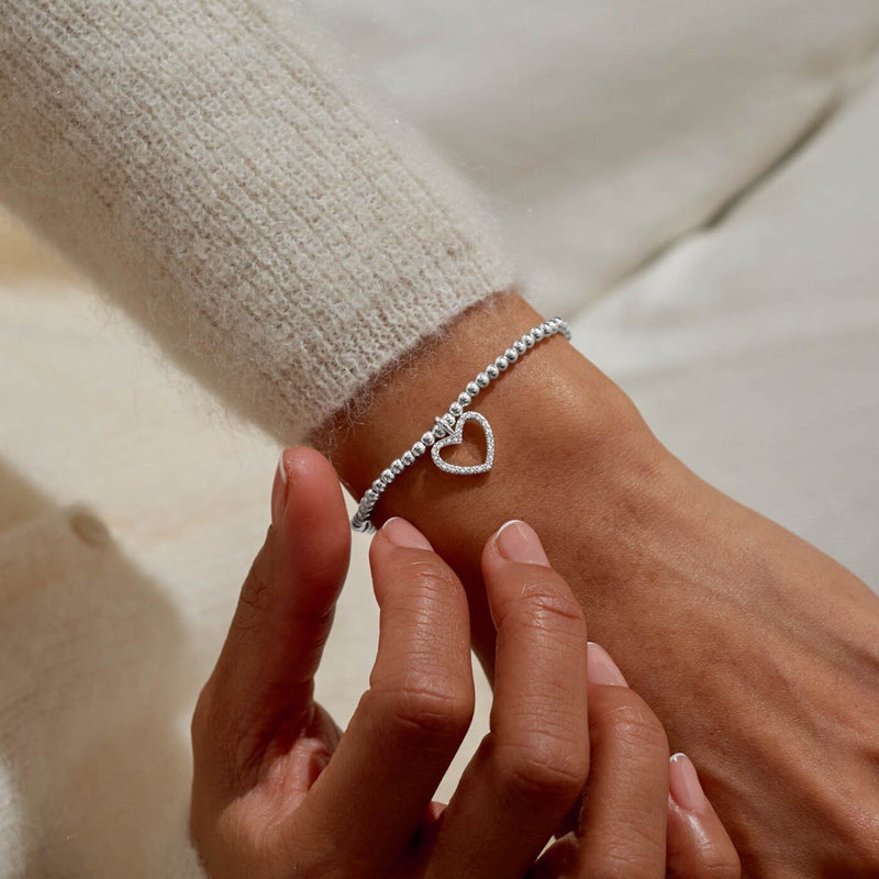 Joma “Merry Christmas” beaded bracelet styled on wrist; elegant holiday jewellery piece – ideal Christmas gifts for her.
