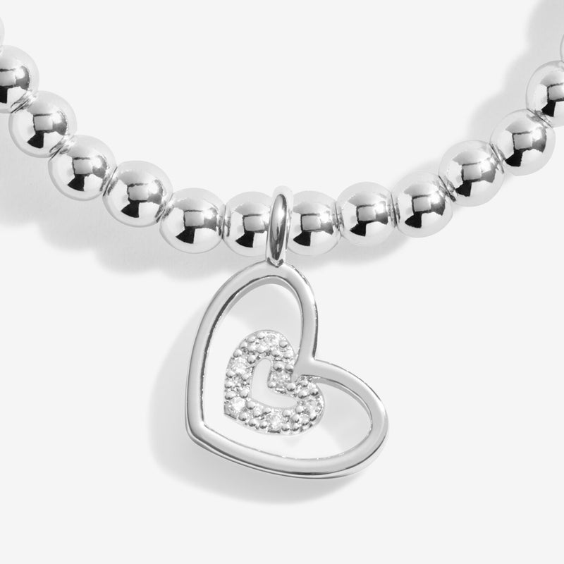 Close‑up of pavé inner heart set inside polished open‑heart charm on Grandma Christmas bracelet by Joma Jewellery.

